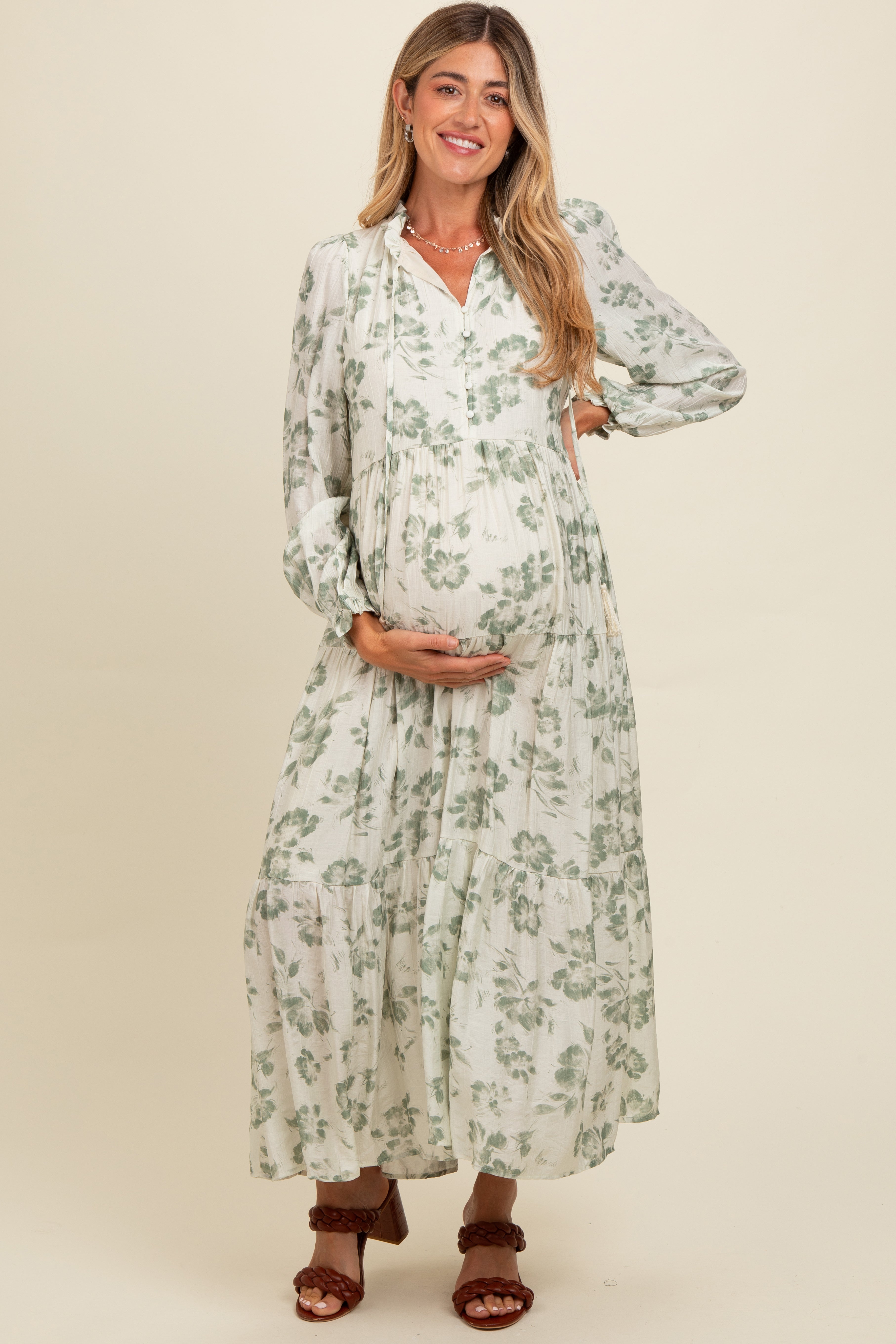 Olivfarbenes Umstands-Maxikleid mit Blumenmuster, Knopfleiste, Stufenrock und langen Ärmeln